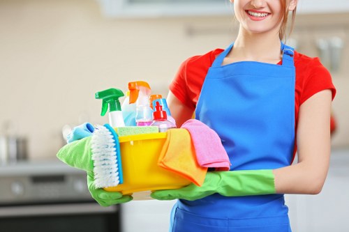 Cleaner preparing oven cleaning area with safety equipment